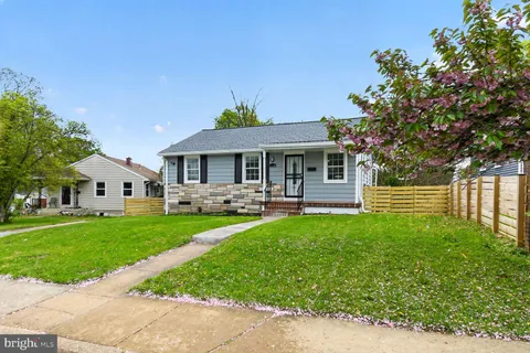 a kitchen with white cabinets and sink