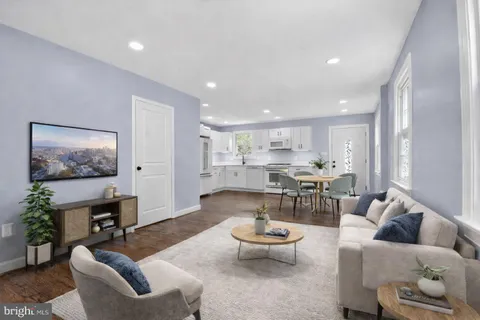 a bedroom with a large bed and windows