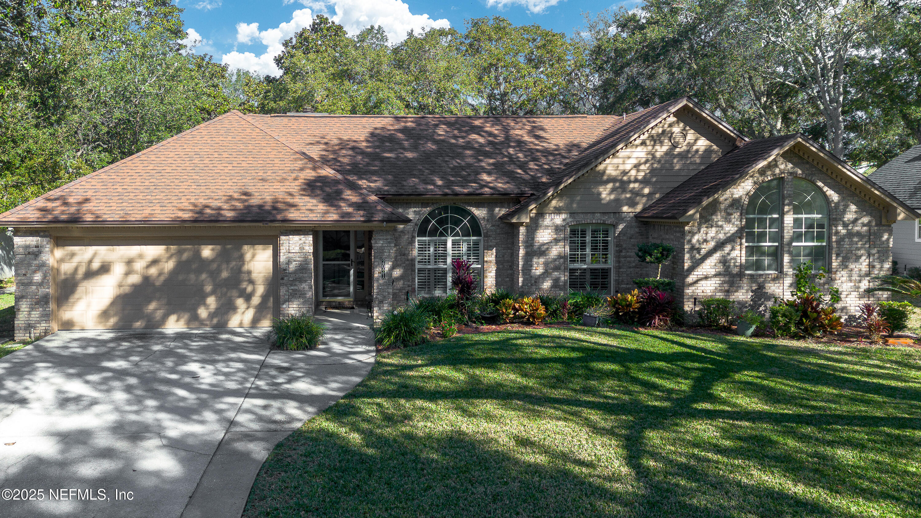 a view of a house with a yard and pathway