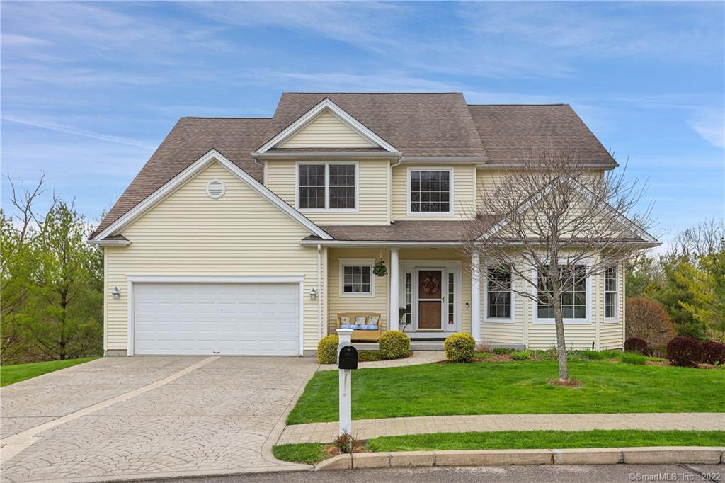 2 Spring Ridge Court, Unit 2 Danbury, CT 06811 - Photo 1 of 1 a front view of a house with a yard