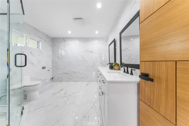 a living room with furniture a wooden floor and pool table