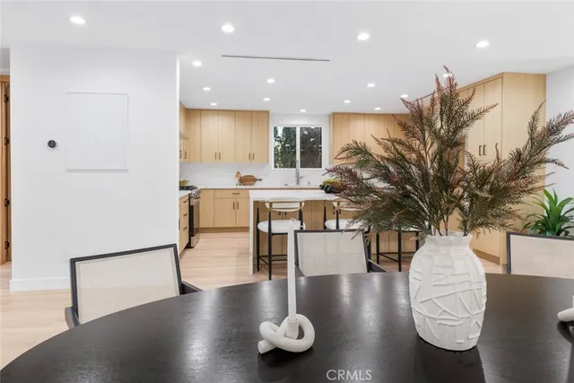 a large kitchen with stainless steel appliances lots of counter space and a sink