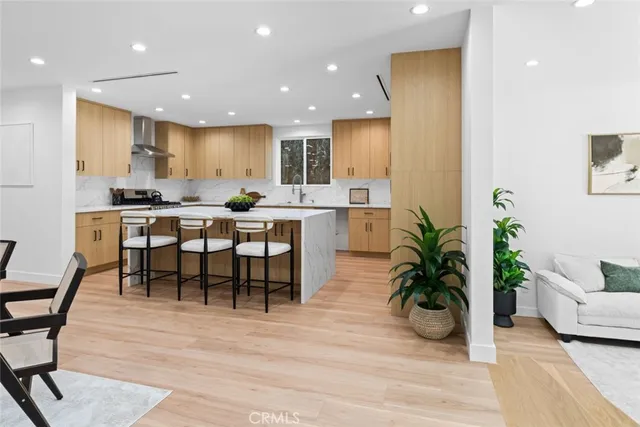 a kitchen with a sink a stove and cabinets