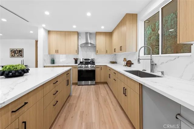 a kitchen with a sink a stove and a refrigerator