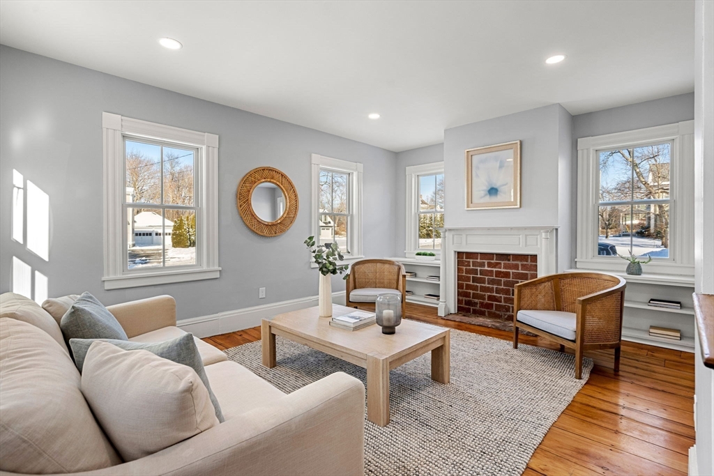 201 Main Street Rowley, MA 01969 - Photo 14 of 42 a living room with furniture a fireplace and a large window