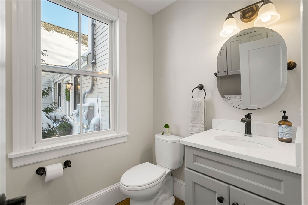 201 Main Street Rowley, MA 01969 - Photo 19 of 42 a bathroom with a toilet sink and mirror