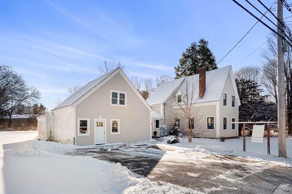 201 Main Street Rowley, MA 01969 - Photo 2 of 42 a view of a white house with a yard and large tree