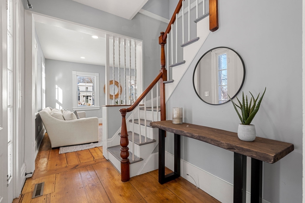 201 Main Street Rowley, MA 01969 - Photo 21 of 42 a living room with furniture a mirror and a wooden floor