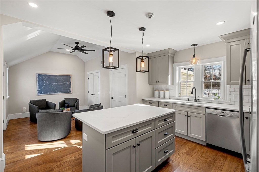 201 Main Street Rowley, MA 01969 - Photo 9 of 42 a kitchen with a sink dishwasher a stove and a refrigerator with wooden floor