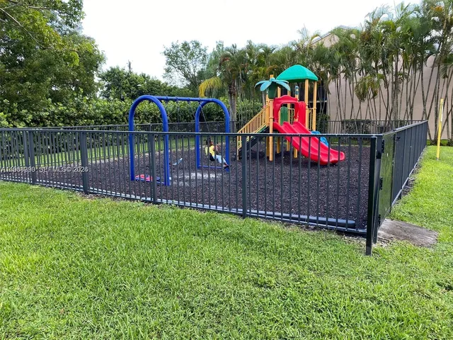 a view of park with wooden stairs and a bench