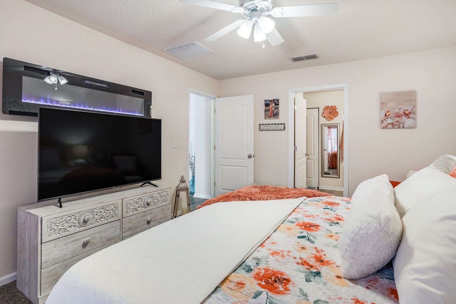 95170 Timberlake Drive Fernandina Beach, FL 32034 - Photo 12 of 36 a bedroom with a flat screen tv on dresser and a chandelier