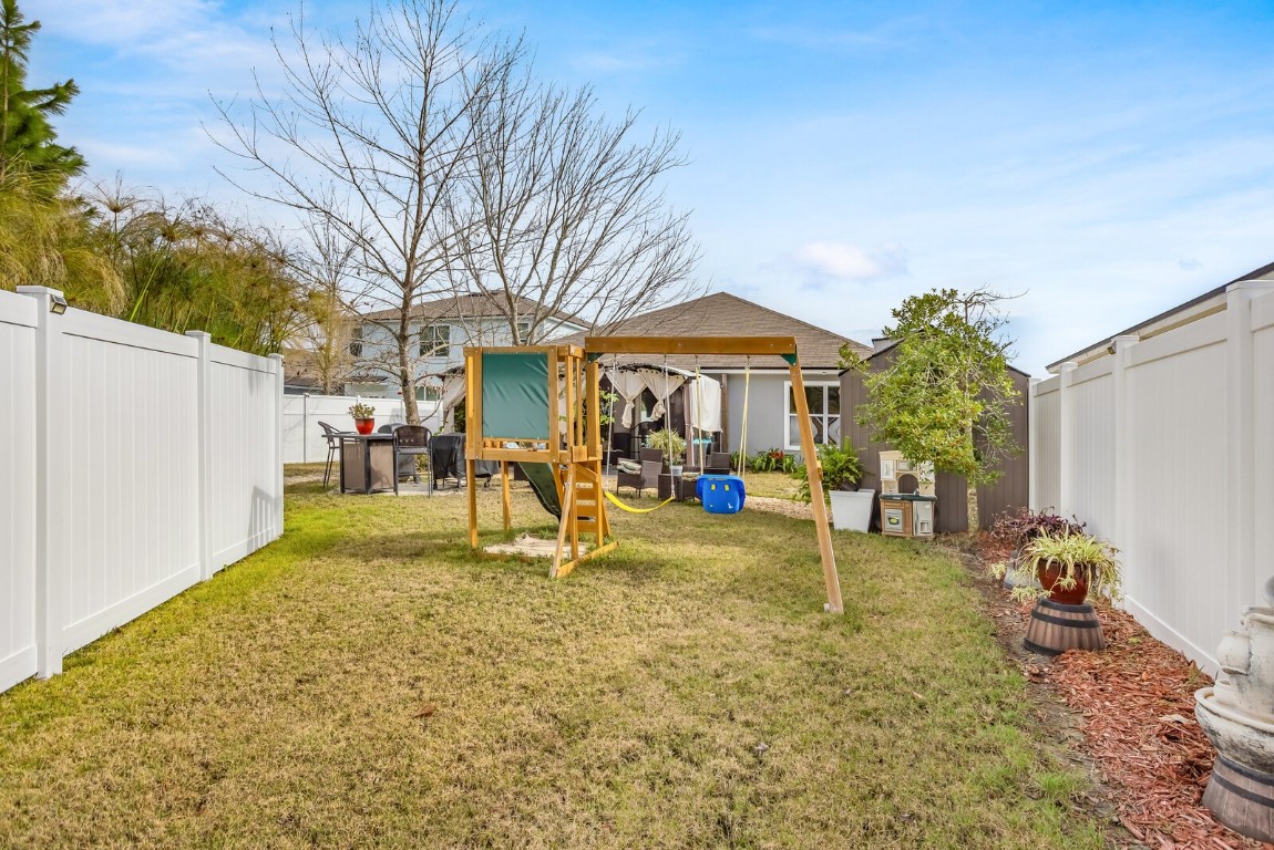 95170 Timberlake Drive Fernandina Beach, FL 32034 - Photo 28 of 36 a view of a house with a yard and sitting area