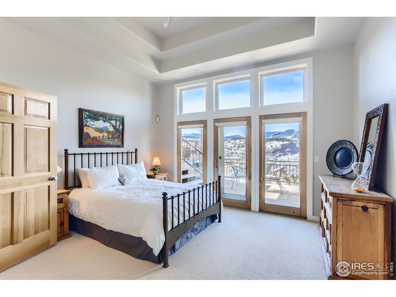 814 Mountain View Drive Lyons, CO 80540 - Photo 20 of 36 a bedroom with a bed a mirror and a window
