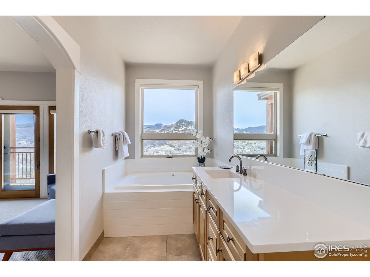 814 Mountain View Drive Lyons, CO 80540 - Photo 24 of 36 a bathroom with a sink a bathtub and a window