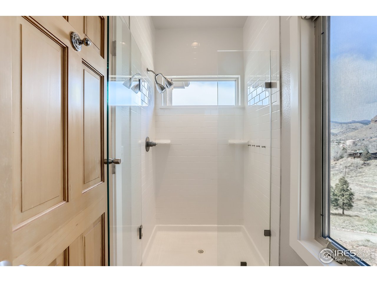 814 Mountain View Drive Lyons, CO 80540 - Photo 25 of 36 a bathroom with a glass shower door