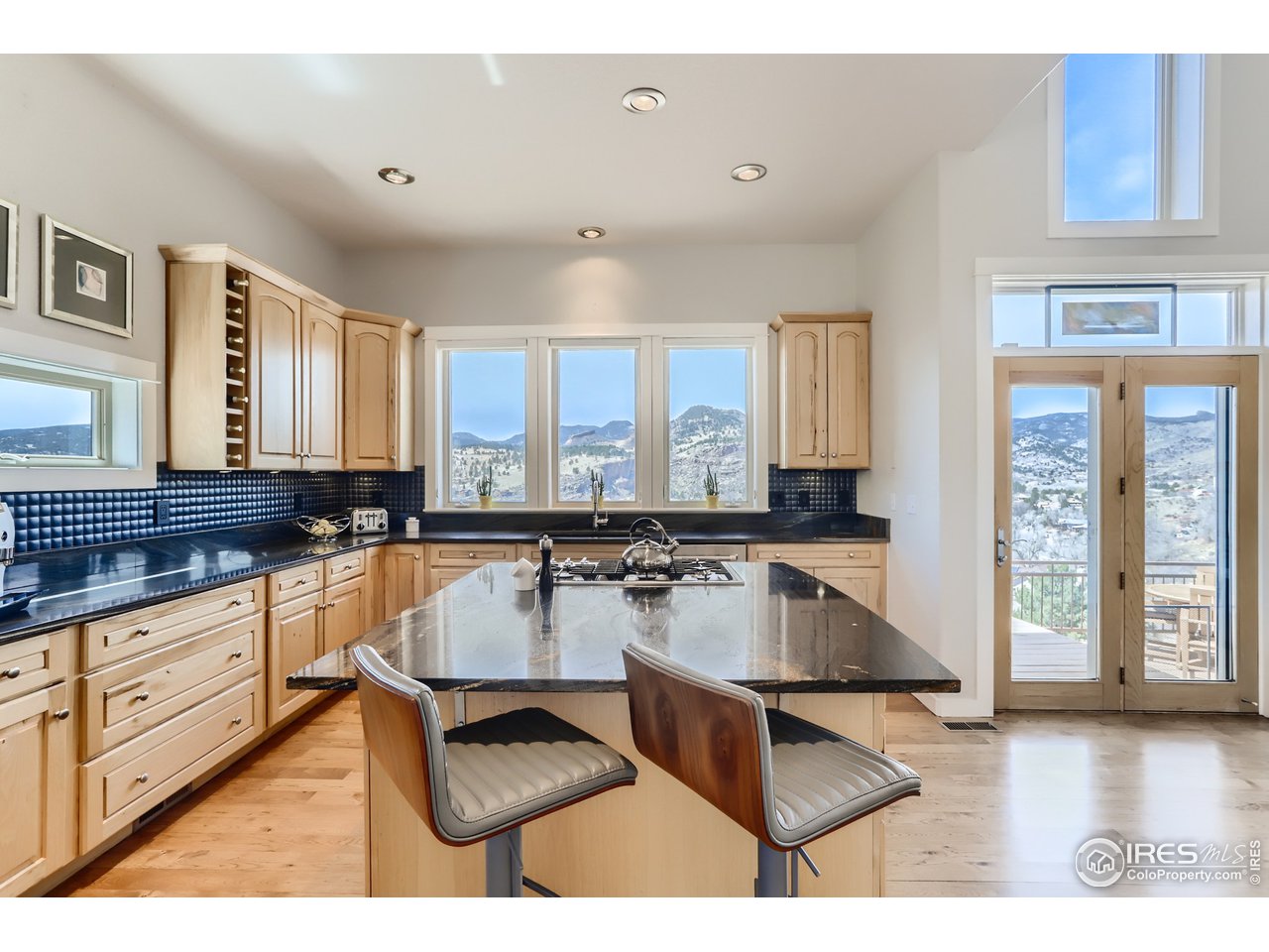 814 Mountain View Drive Lyons, CO 80540 - Photo 10 of 36 a kitchen with granite countertop a sink and white cabinets