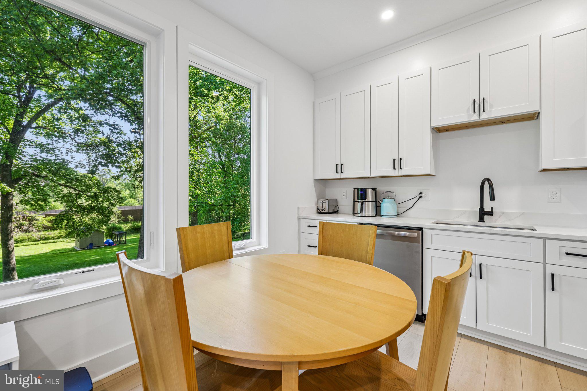 4315 Pinetree Road Rockville, MD 20853 - Photo 7 of 28 a kitchen with a table chairs sink and cabinets