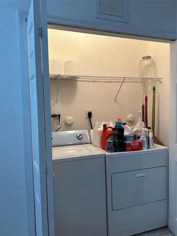 a utility room with dryer washer and a window