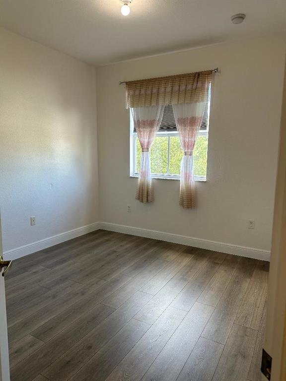 8824 Southwest 153rd Court Miami, FL 33196 - Photo 16 of 25 an empty room with wooden floor and windows