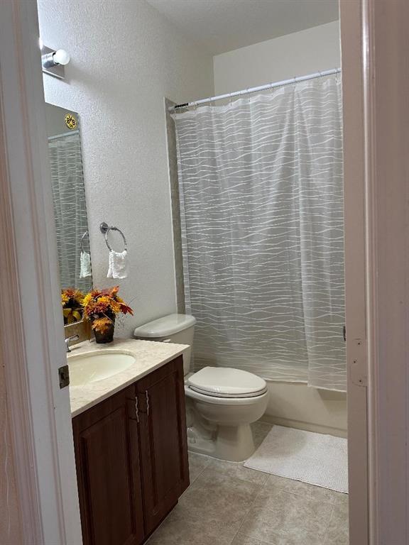 8824 Southwest 153rd Court Miami, FL 33196 - Photo 18 of 25 a bathroom with a sink a toilet and shower curtain