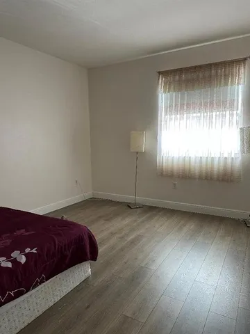 a spacious bedroom with a bed and window