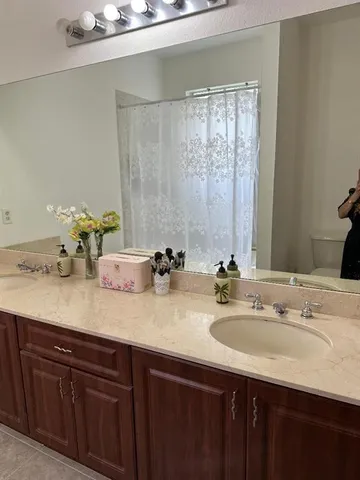 a bathroom with double sink and a mirror