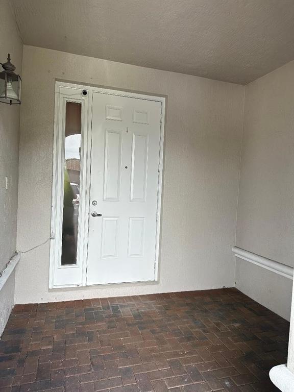 8824 Southwest 153rd Court Miami, FL 33196 - Photo 3 of 25 a view of an empty room with wooden floor and a cabinet