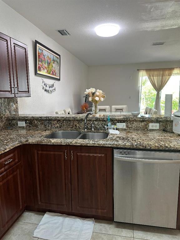 8824 Southwest 153rd Court Miami, FL 33196 - Photo 9 of 25 a kitchen with granite countertop a sink and cabinets