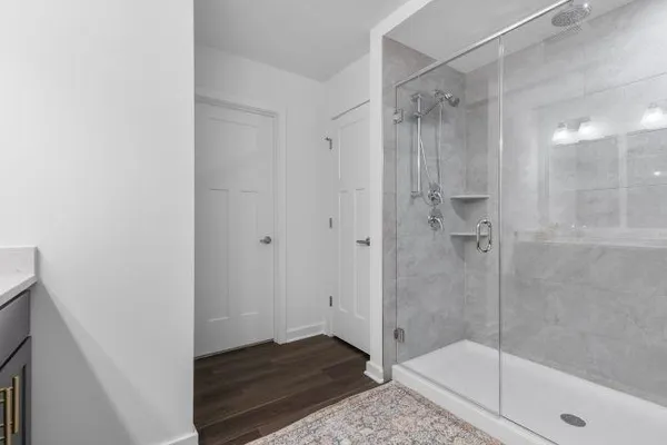 a bedroom with a baby bed a couch and dresser