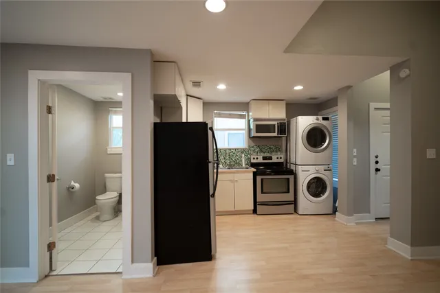 a view of a kitchen with a refrigerator and washer
