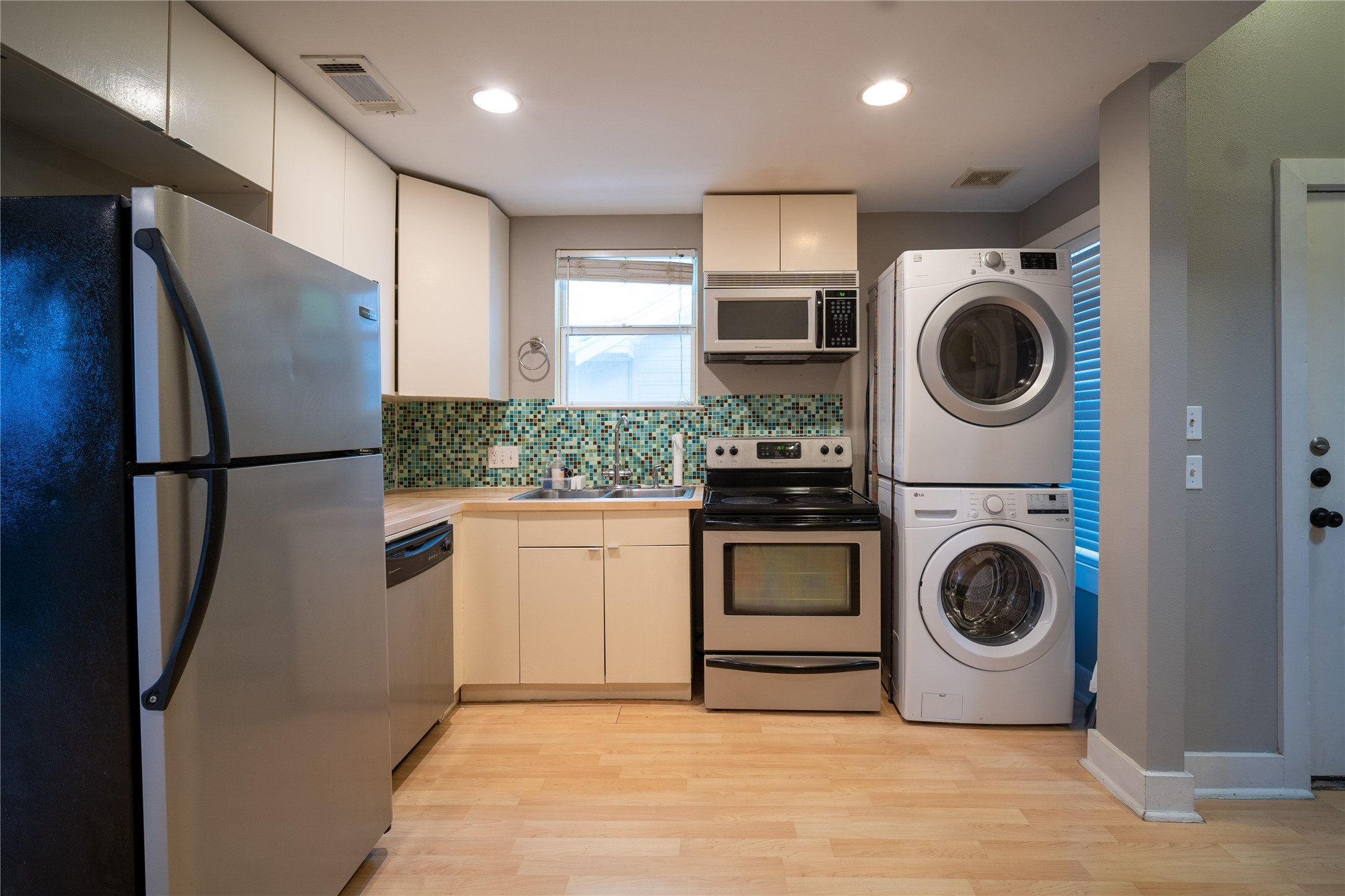 711 Graham Place, Unit B Austin, TX 78705 - Photo 2 of 13 a utility room with sink dryer and washer