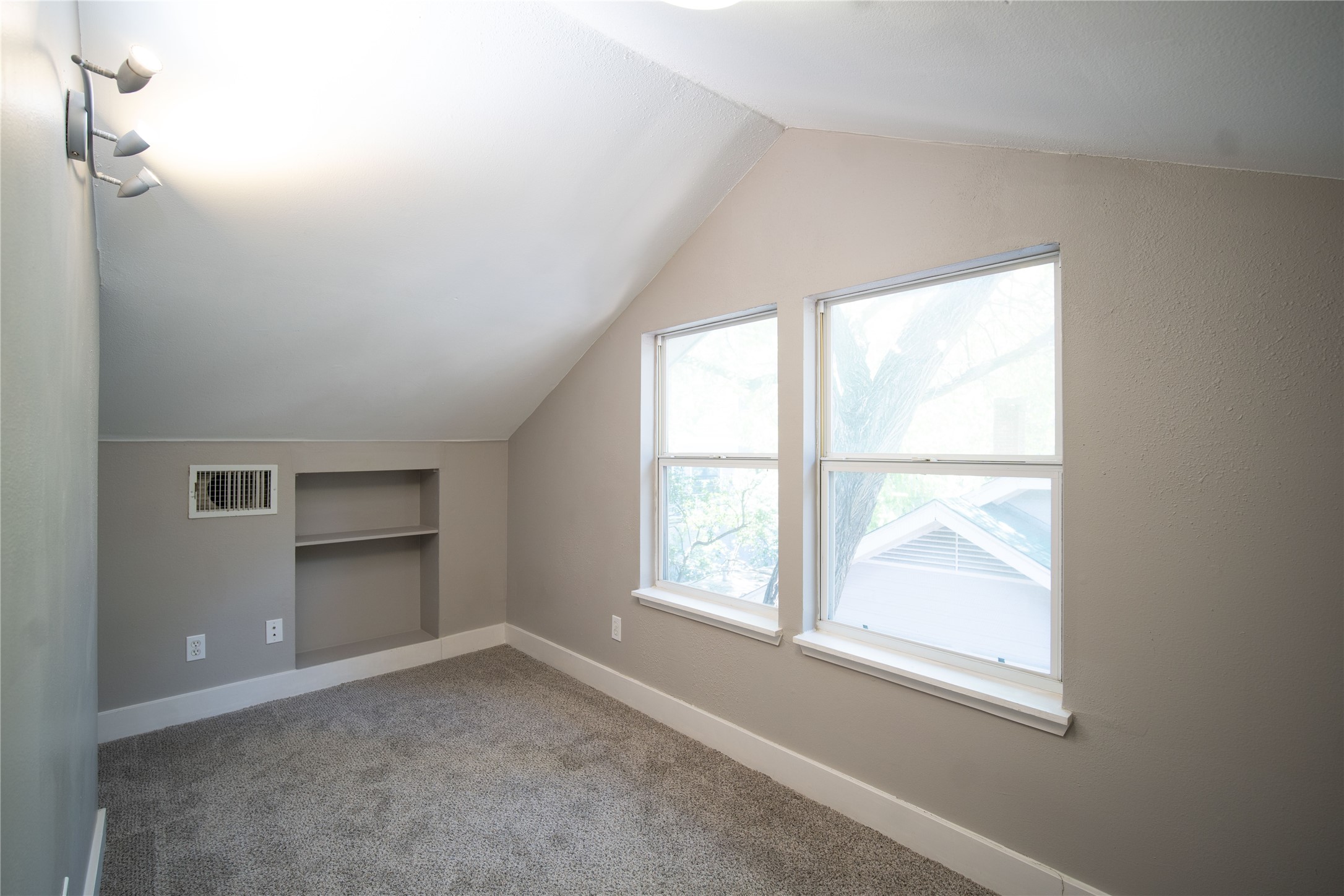 711 Graham Place, Unit B Austin, TX 78705 - Photo 8 of 13 an empty room with windows and closet