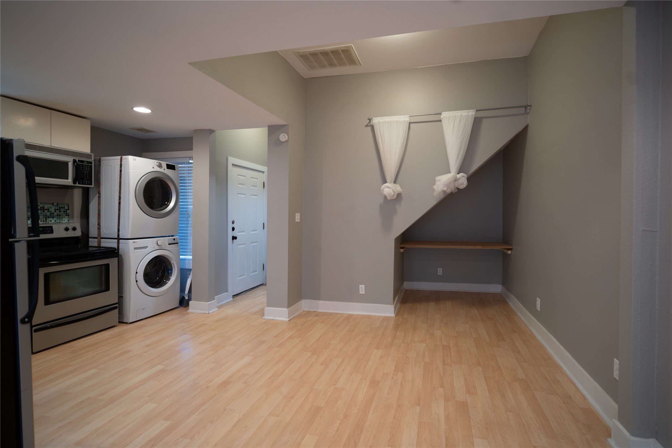 711 Graham Place, Unit B Austin, TX 78705 - Photo 10 of 13 a view of a hallway with washer and dryer