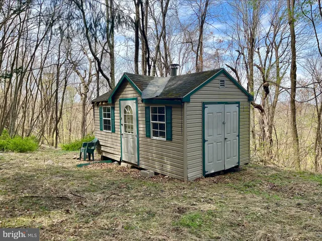 a view of a house with a yard and wooden fence