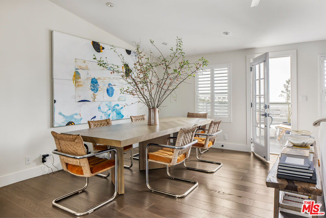 29500 Heathercliff Road, Unit 235 Malibu, CA 90265 - Photo 12 of 32 a view of a dining room with furniture and wooden floor