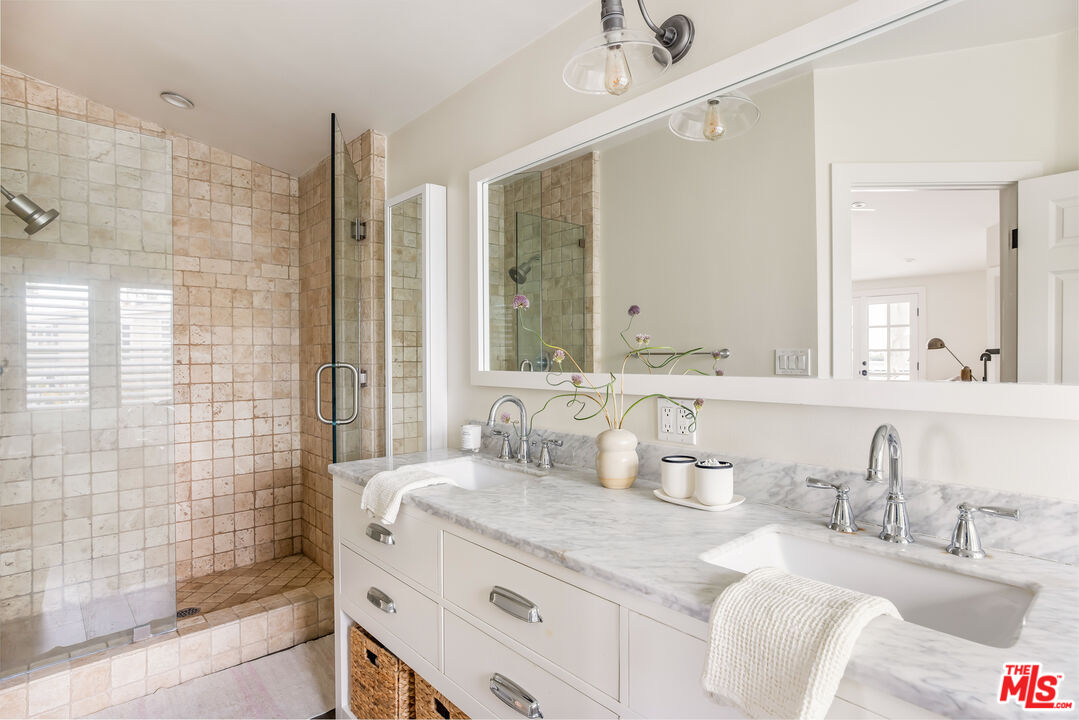 29500 Heathercliff Road, Unit 235 Malibu, CA 90265 - Photo 16 of 32 a bathroom with a granite countertop sink mirror and double