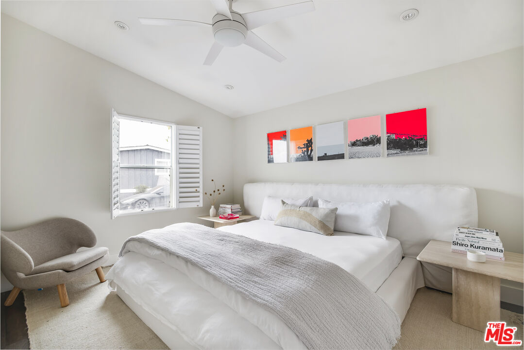 29500 Heathercliff Road, Unit 235 Malibu, CA 90265 - Photo 19 of 32 a bedroom with a bed and a chandelier