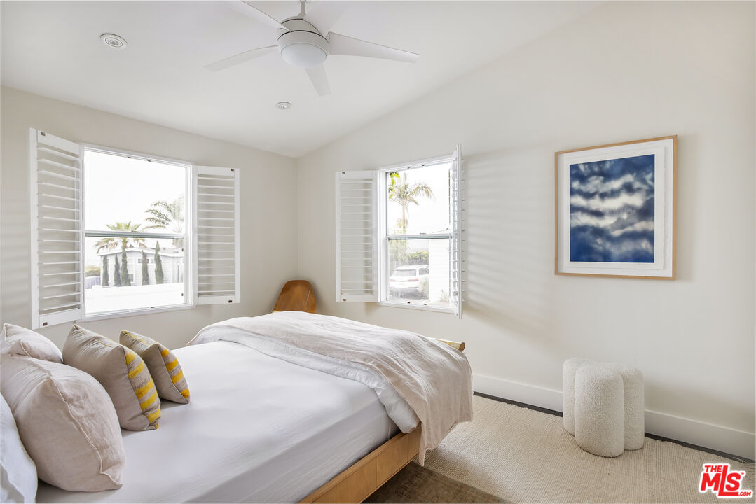 29500 Heathercliff Road, Unit 235 Malibu, CA 90265 - Photo 21 of 32 a bedroom with bed and a large window