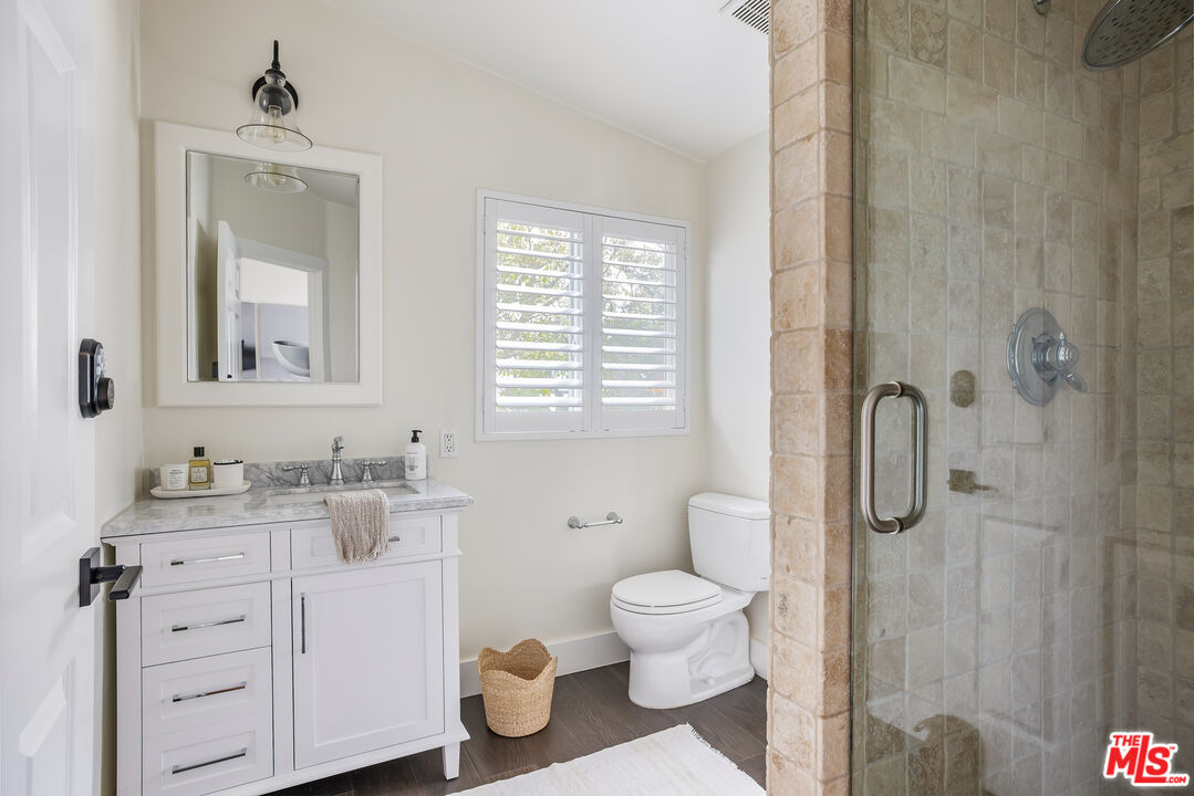 29500 Heathercliff Road, Unit 235 Malibu, CA 90265 - Photo 24 of 32 a bathroom with a granite countertop toilet sink and mirror