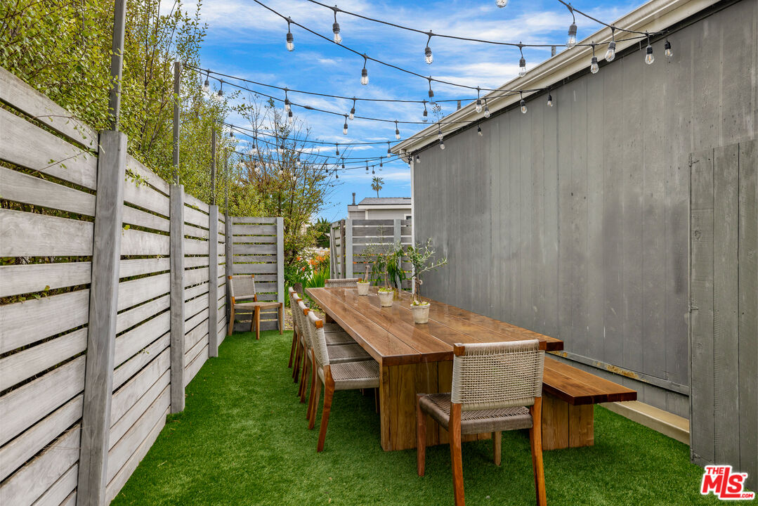 29500 Heathercliff Road, Unit 235 Malibu, CA 90265 - Photo 27 of 32 a backyard of a house with table and chairs