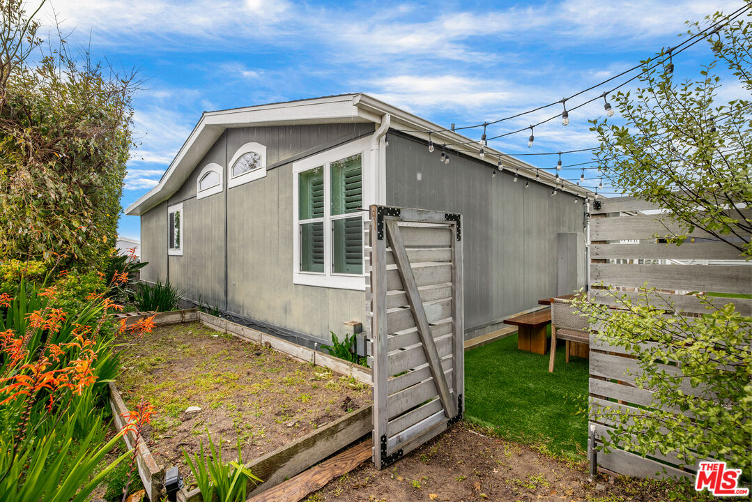 29500 Heathercliff Road, Unit 235 Malibu, CA 90265 - Photo 29 of 32 a front view of a house with garden