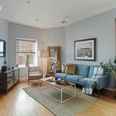 a living room with furniture potted plant and a window