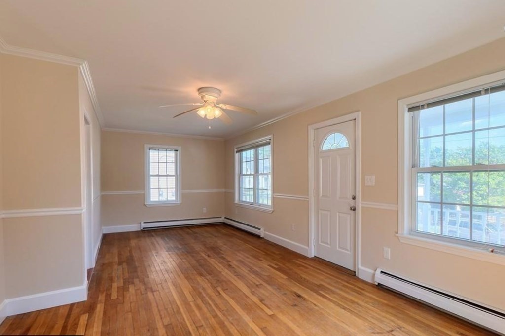 142 East Meadow Road Lowell, MA 01854 - Photo 15 of 28 a view of an empty room with wooden floor and a window