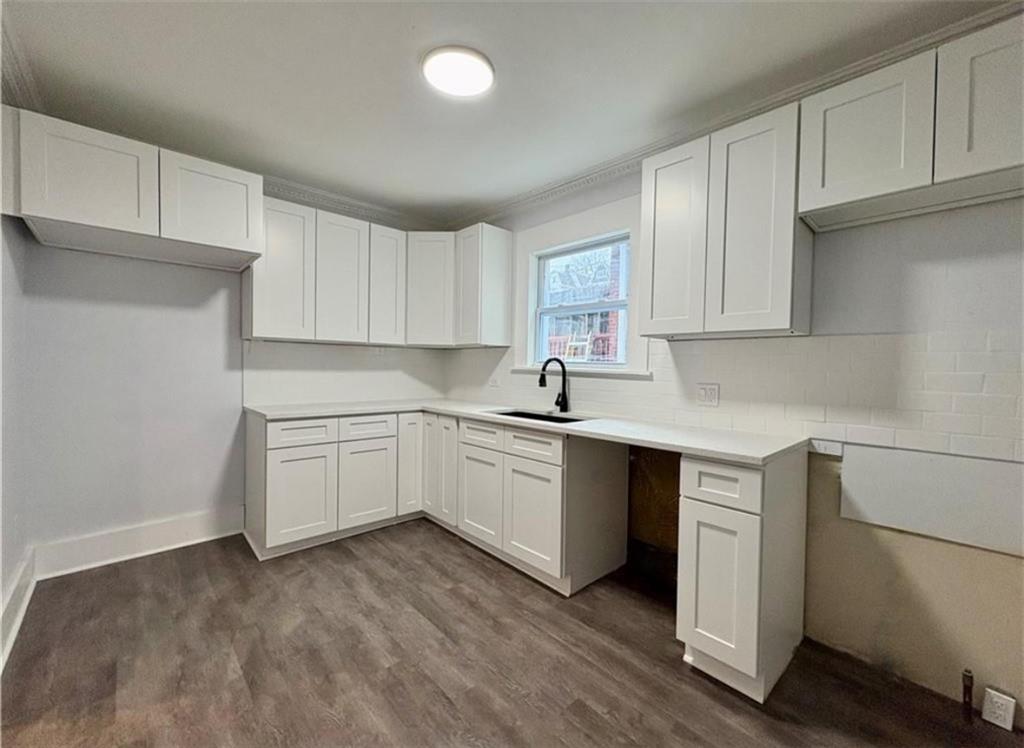 1416 Ridge Avenue Coraopolis, PA 15108 - Photo 11 of 24 a kitchen with granite countertop white cabinets and white appliances