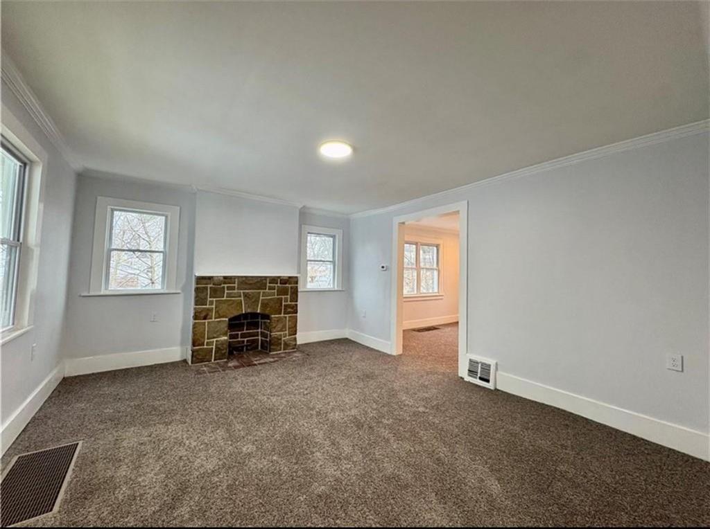 1416 Ridge Avenue Coraopolis, PA 15108 - Photo 3 of 24 an empty room with a fireplace and windows