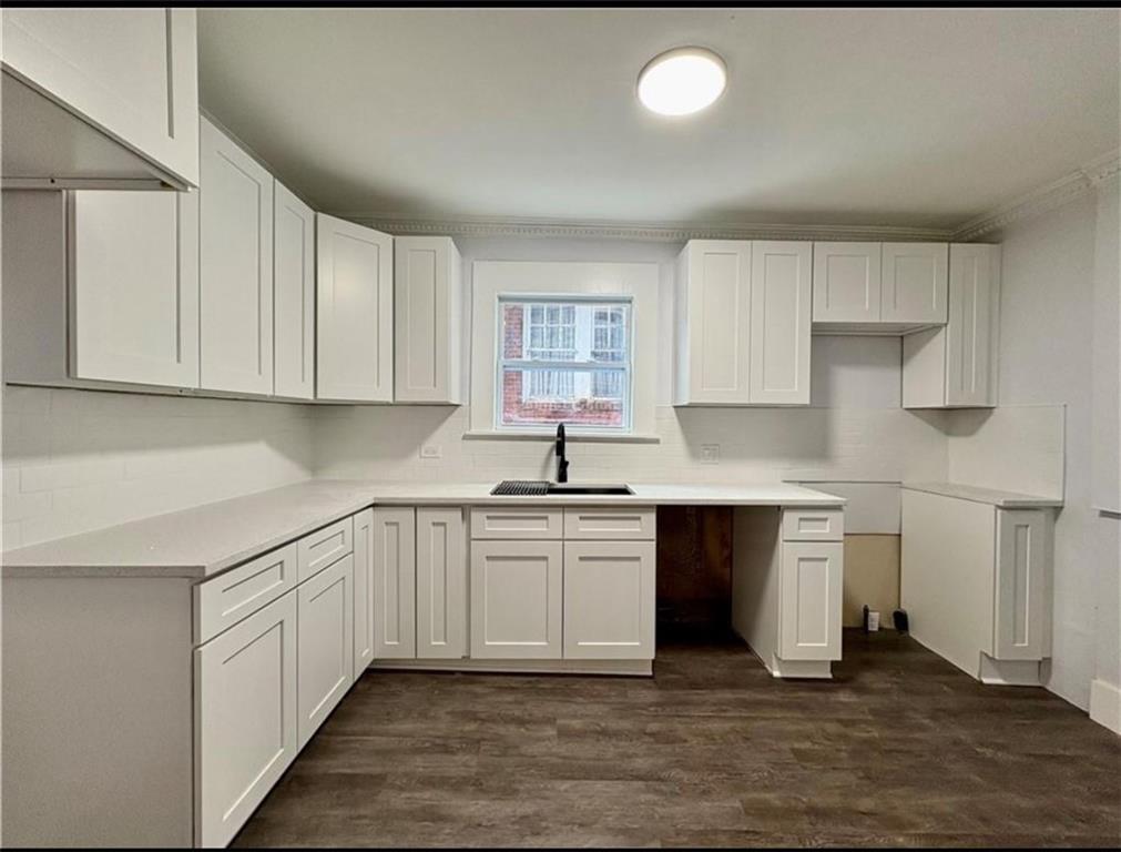 1416 Ridge Avenue Coraopolis, PA 15108 - Photo 10 of 24 a kitchen with stainless steel appliances granite countertop a sink and cabinets with wooden floor