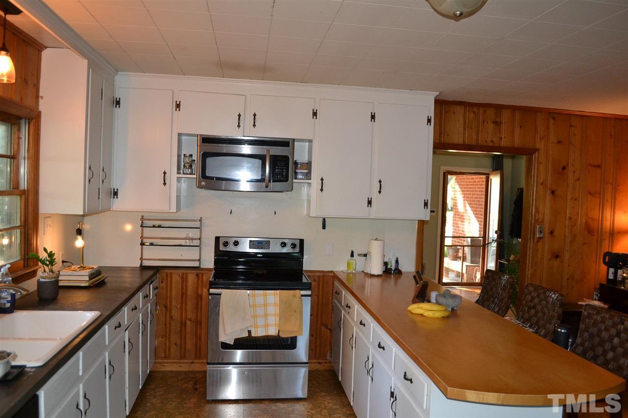 1604 Carson Street Raleigh, NC 27608 - Photo 11 of 28 a kitchen with stainless steel appliances a stove a sink a microwave a refrigerator and cabinets