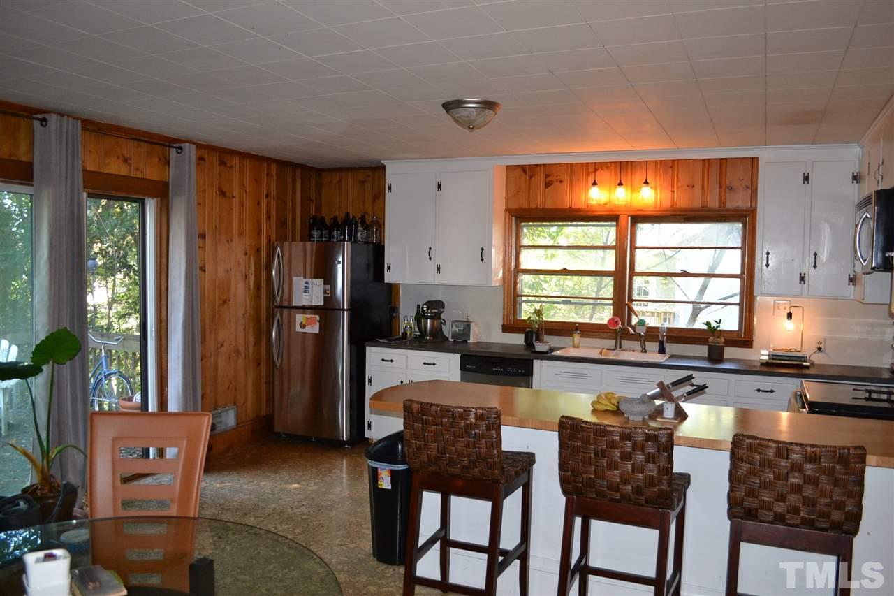 1604 Carson Street Raleigh, NC 27608 - Photo 12 of 28 a large kitchen with a table and chairs
