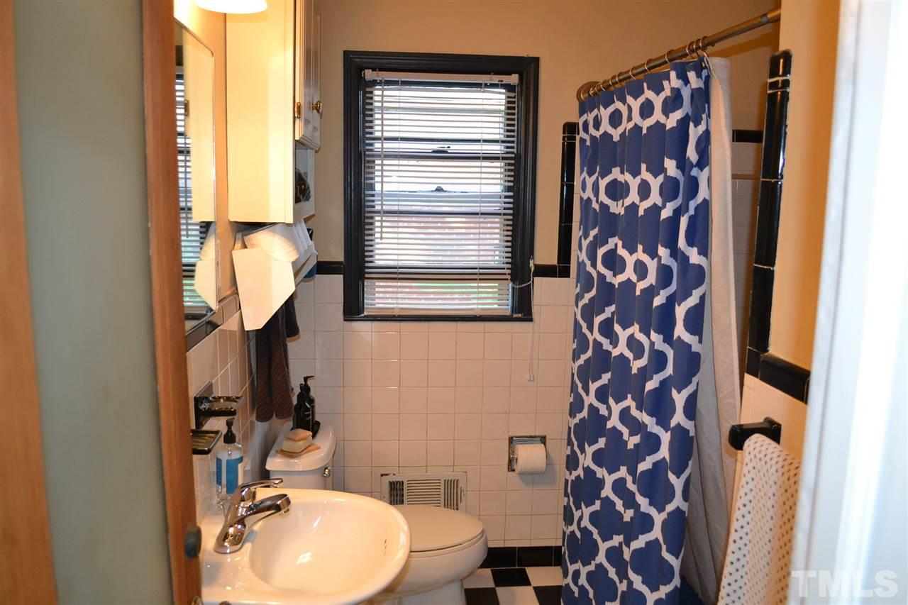 1604 Carson Street Raleigh, NC 27608 - Photo 15 of 28 a bathroom with a toilet a sink and a mirror