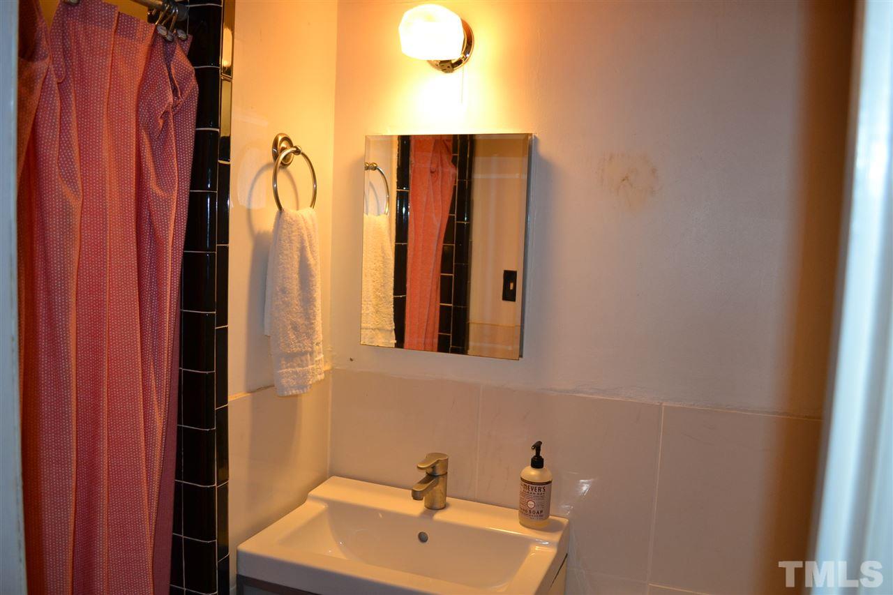 1604 Carson Street Raleigh, NC 27608 - Photo 20 of 28 a bathroom with a sink and mirror